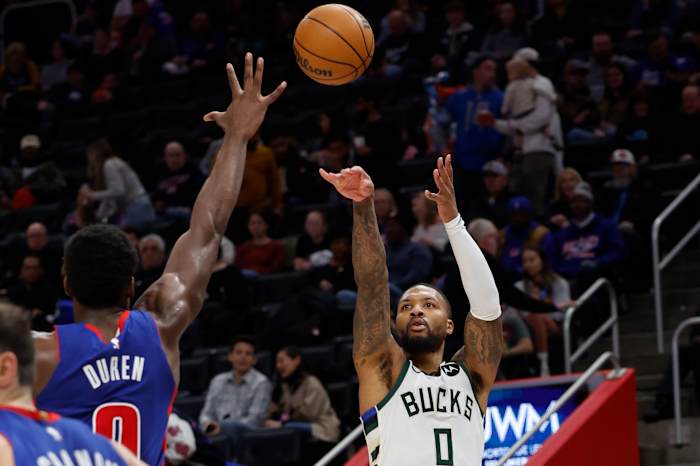 Milwaukee Bucks guard Damian Lillard (0) shoots on Detroit Pistons center Jalen Duren (0)